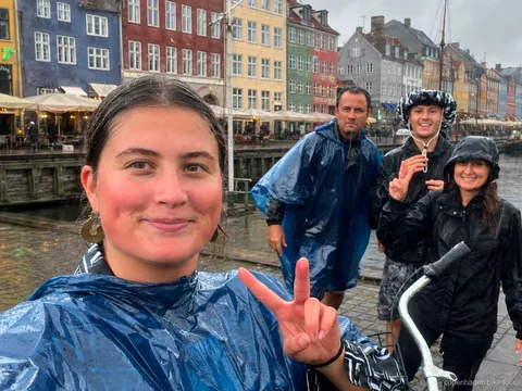 Small group cycling into Freetown Christiania on a guided Copenhagen bike tour