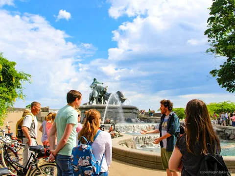 Small group cycling across Inderhavnsbroen on a Copenhagen top sights bike tour